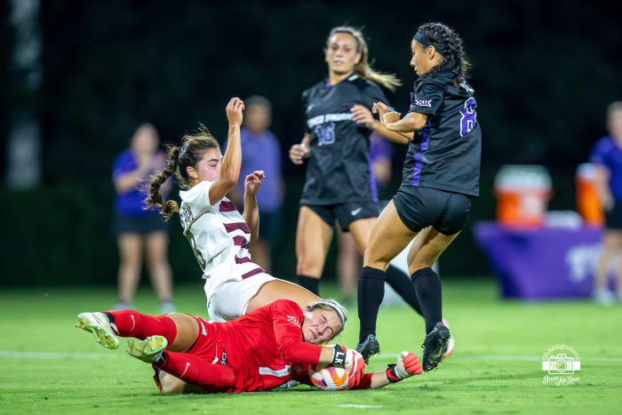 Lauren Kellett (1) makes a diving save in traffic.